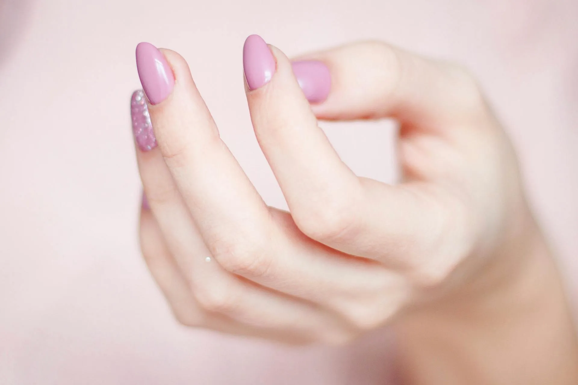 Pink nails over neutral pink backdrop
